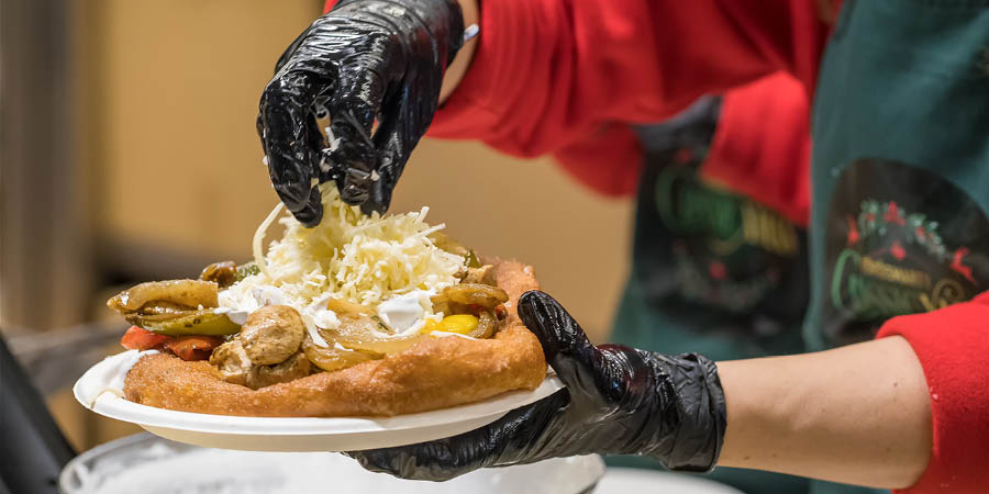 Hungarian lángos, served with vegetables, cheese and sour cream